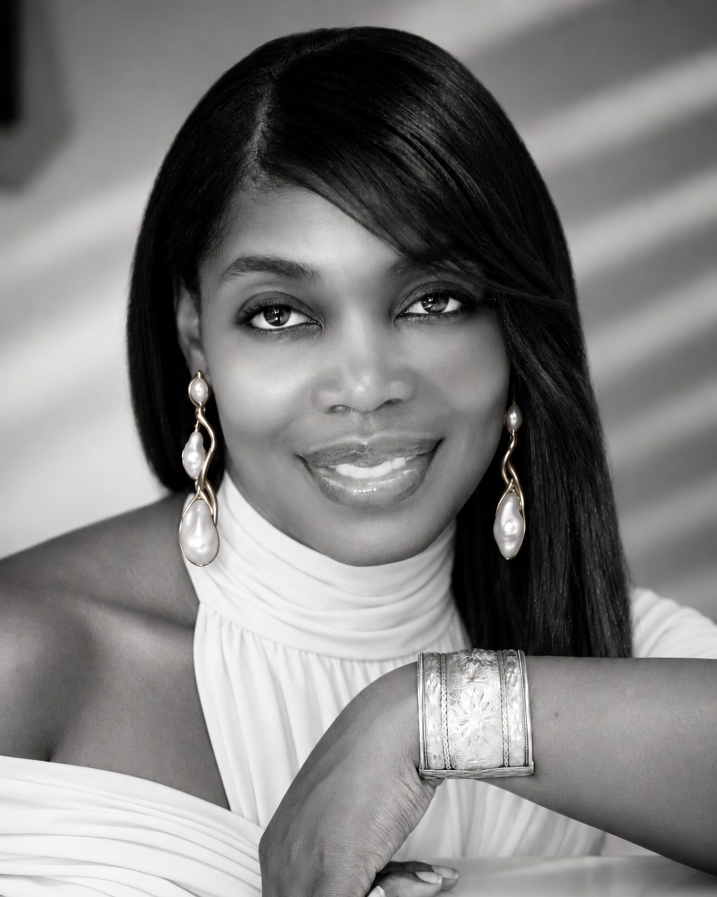 Black-and-white portrait of Maria Lören in a white halter top with pearl earrings.